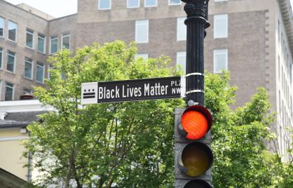 Black and white street sign for Black Lives Matter Plaza