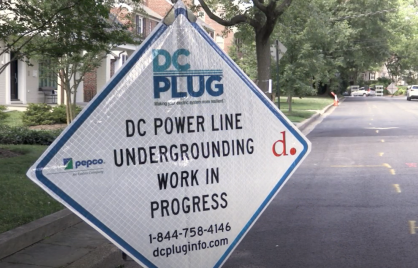 white sign with black letters announcing DC PLUG