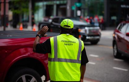 Pedestrian safety officer directing traffic in Washington DC 