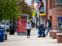 Bus shelter with pedestrians passing by