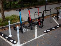 three deckles scooters in an on-street micro mobility corral