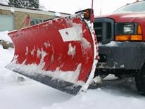 Ready for Action - DC Winter Snow and Ice Plan - red snow plow attached to DDOT truck, preparing to plow snow from city street