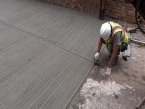 Worker repaving alley